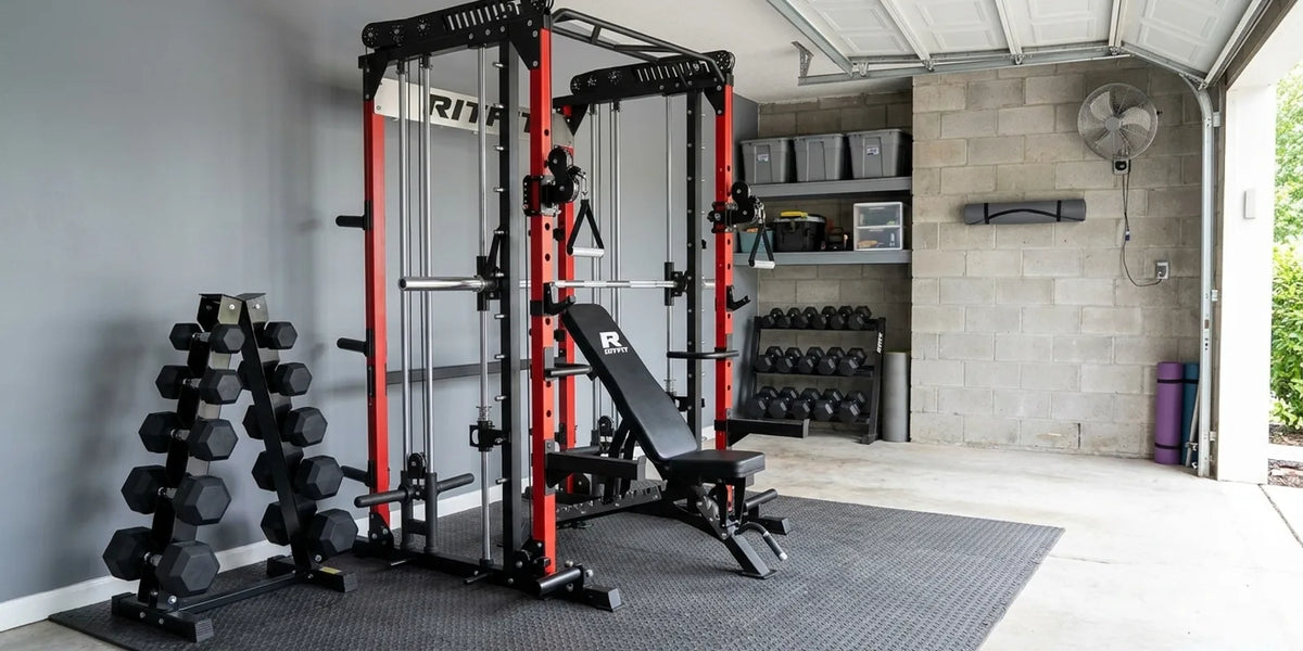 Small home gym layout inside a 200 square foot garage bay with a RitFit smith machine, adjustable bench and dumbbell rack