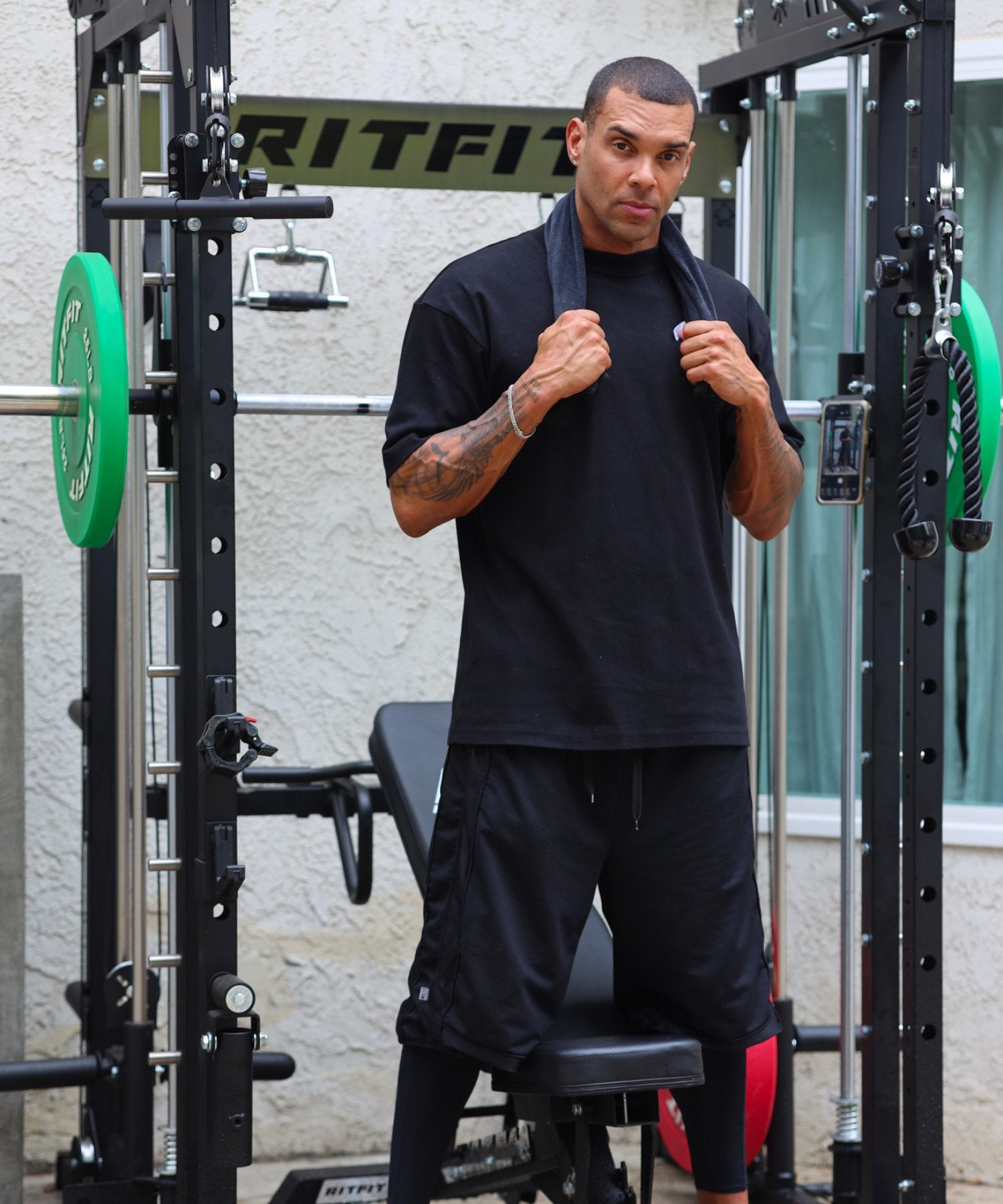 Jamaal Lewis inhis home gym with a black power rack and green weights