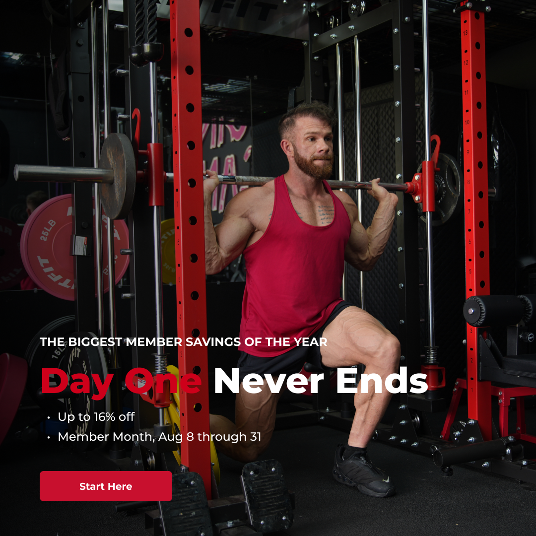 Man performing barbell squat inside red power rack during gym member savings sale event