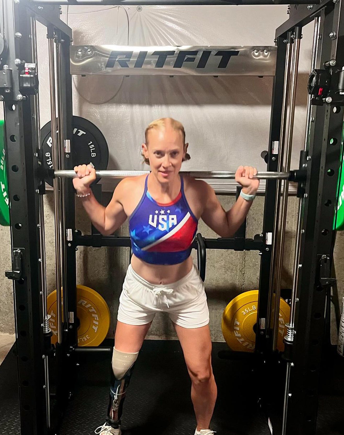 User exercising with RitFit strength training equipment in a home gym environment