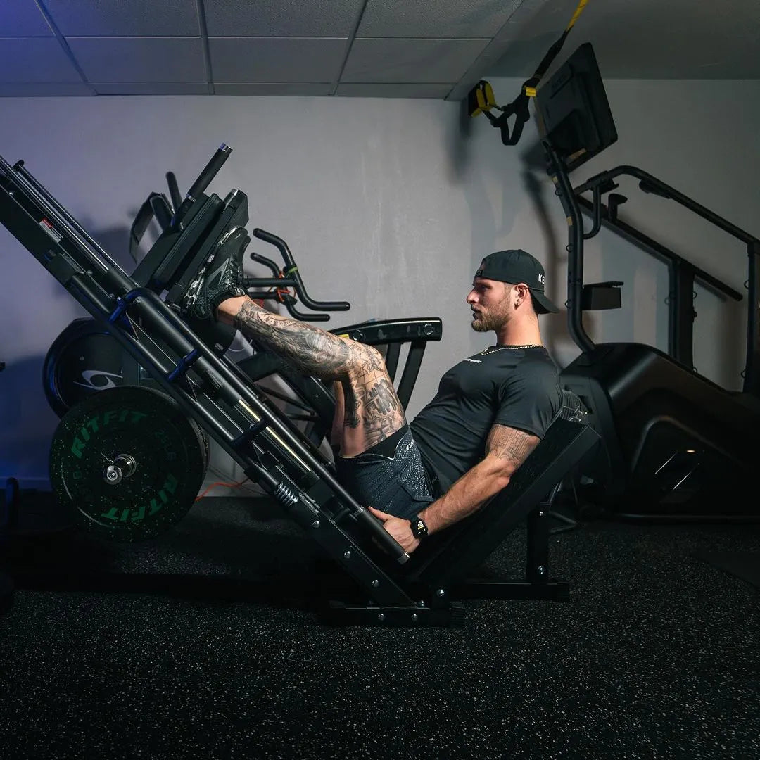 Athlete training lower body on RitFit BLP01 hack squat and leg press machine