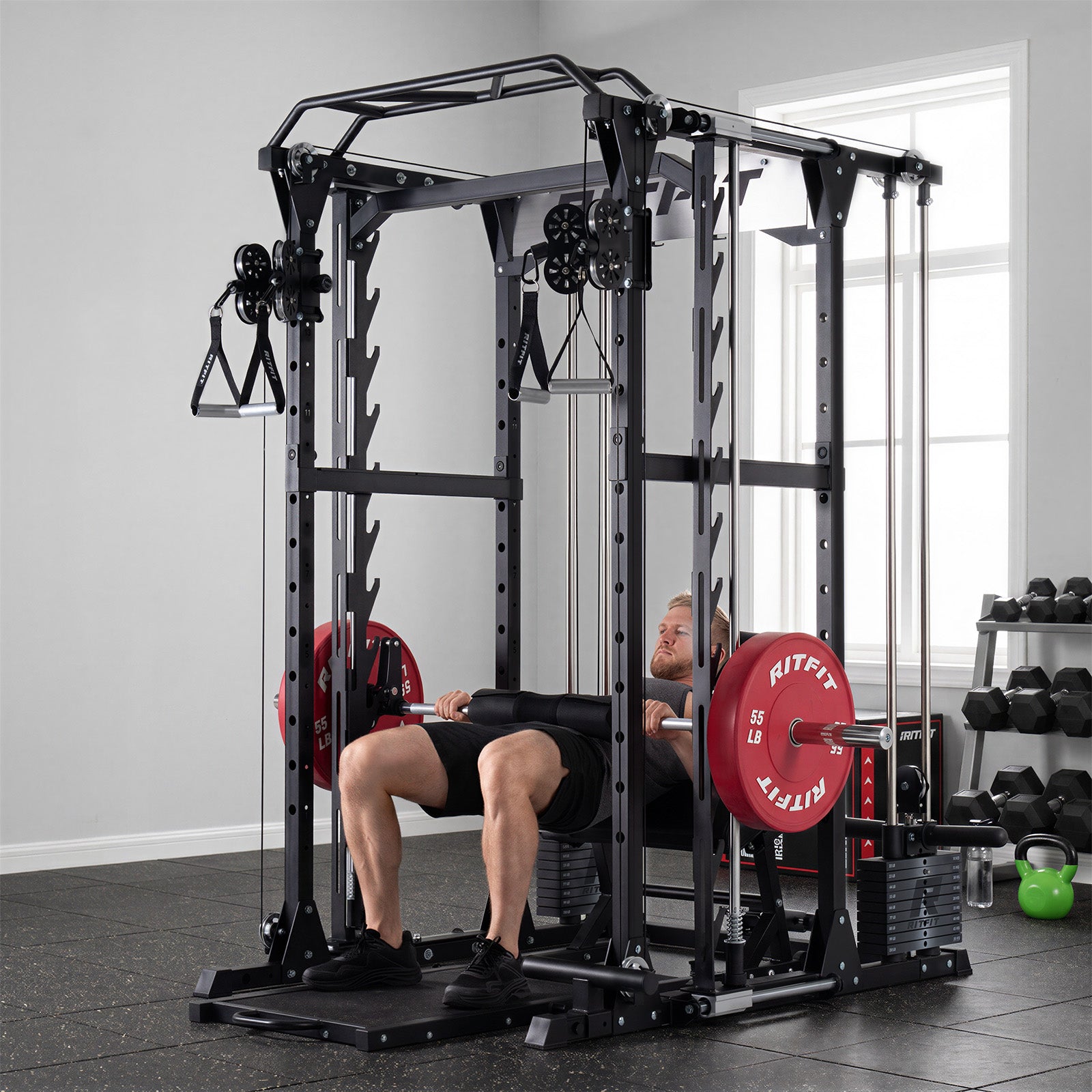 Man performing hip thrust on black RitFit P9 Multi-Functional Modular Power Cage with red weight plates