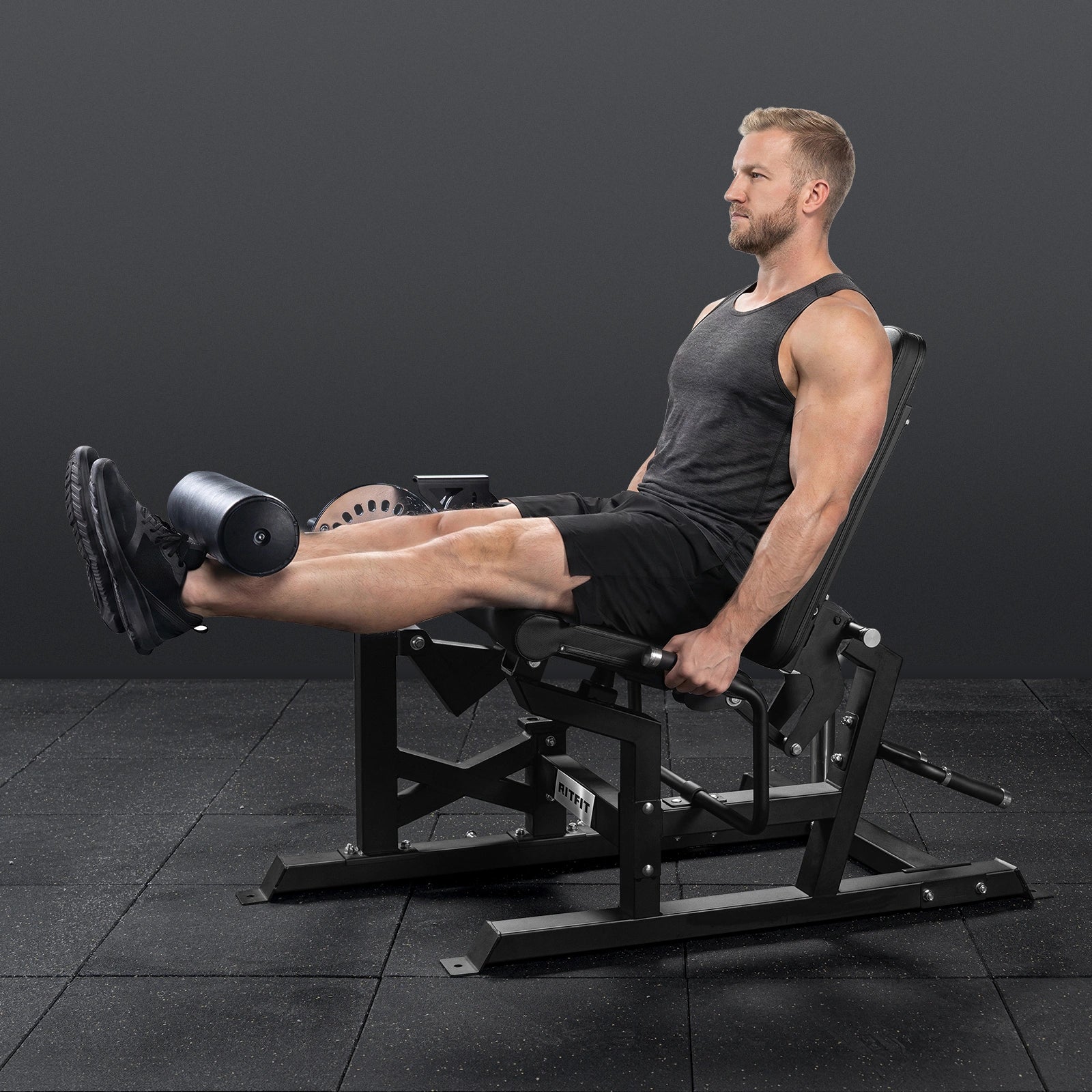RitFit Mustang PRO leg extension and curl machine for strength training, shown in a workout setting with padded seat and weight stacks.