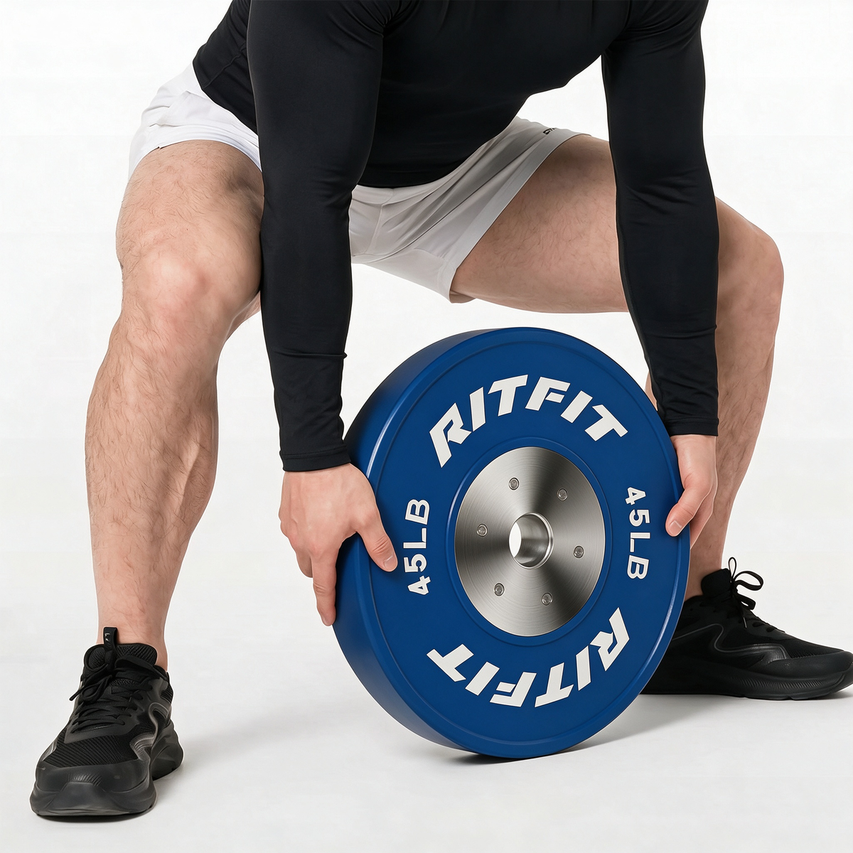Man holding blue RitFit 45LB bumper plate with silver center