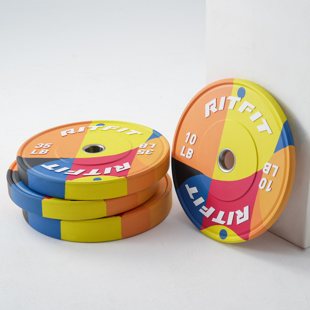 Pair of RitFit Memphis Bumper Plates for home gym, durable weight plates with black finish and branding.