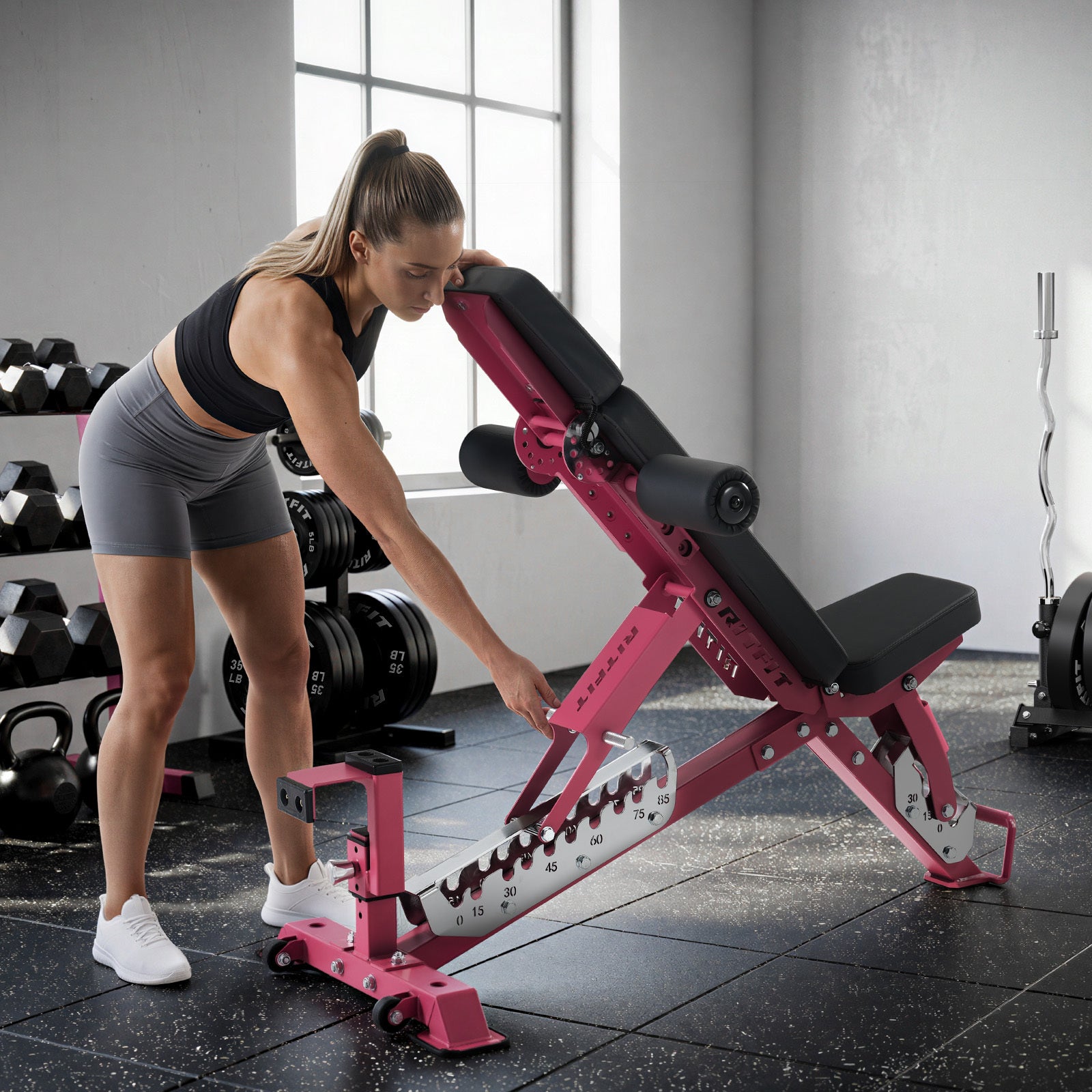 Pink RitFit GATOR adjustable weight bench in a gym setting, featuring a sturdy frame and padded seats for strength training.