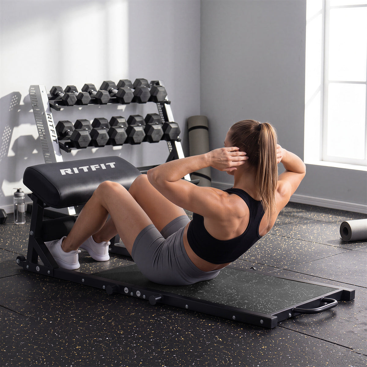 Woman doing crunches on black RitFit P9 PHM02 Glute Power Bundle 3D Smith and Hip Thrust System