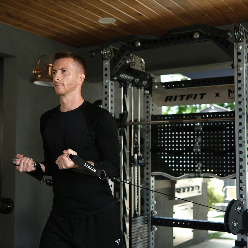 Marco Reus using the cable crossover on the RitFit M3 power rack