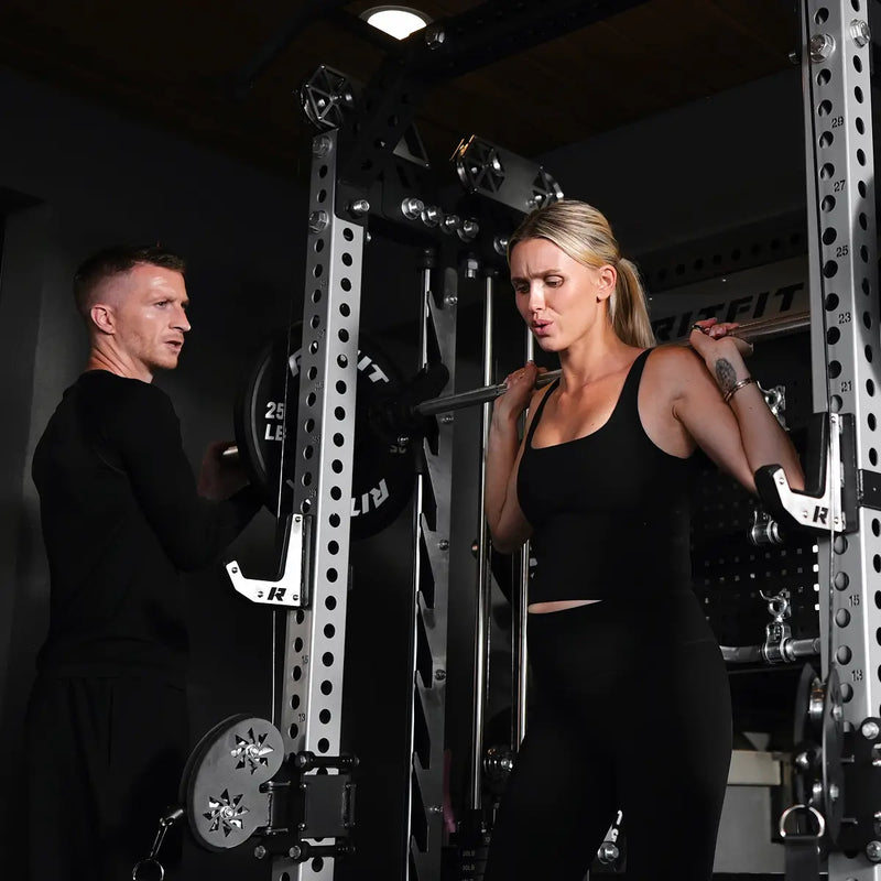 Marco Reus spotting his wife Scarlett during a squat on the RitFit M3 Smith machine