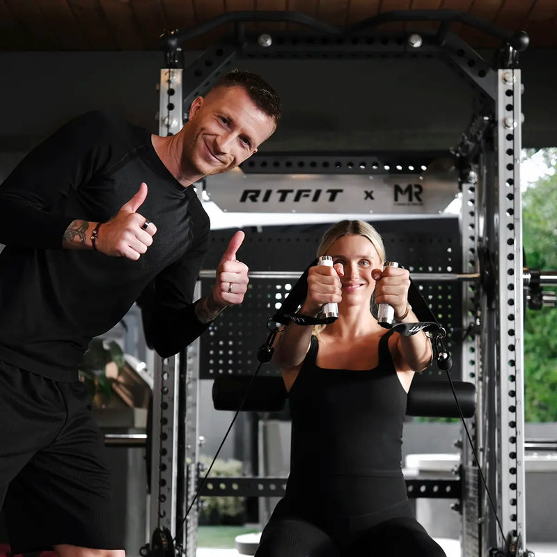 Marco Reus spotting his wife Scarlett during a squat on the RitFit M3 Smith machine