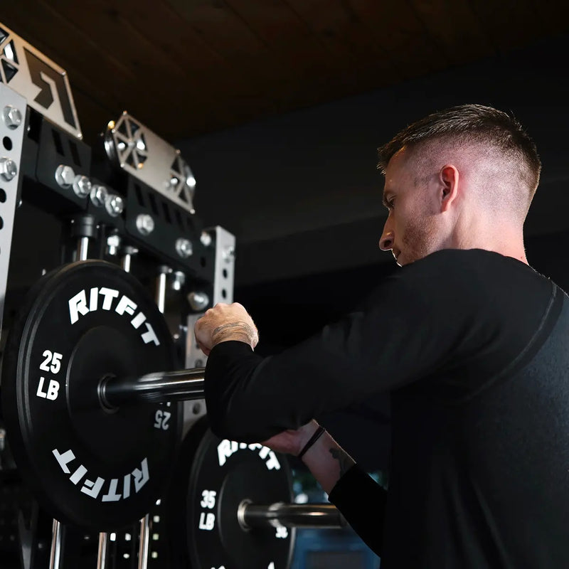 Marco Reus loading RitFit weight plates onto the M3 barbell